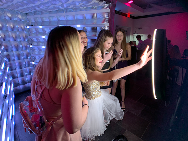 Young guests using the Magic Mirror booth at a Sweet 16