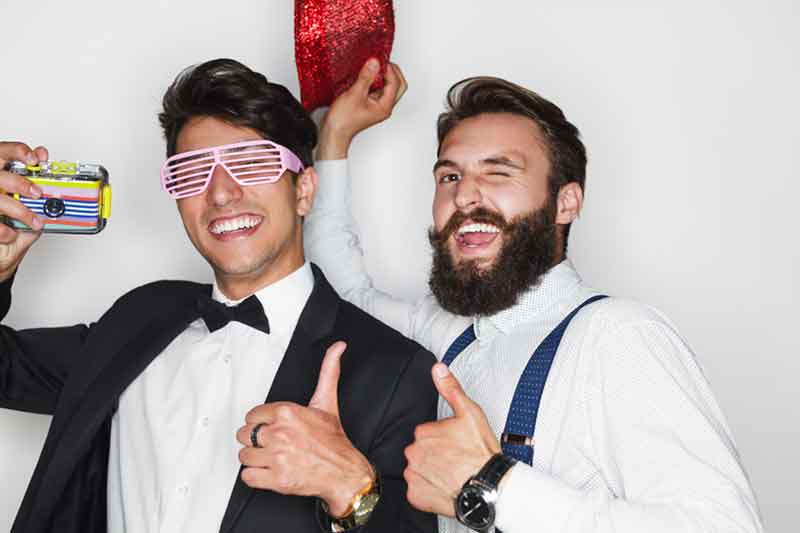 Wedding guests celebrating in formal attire at the photo booth